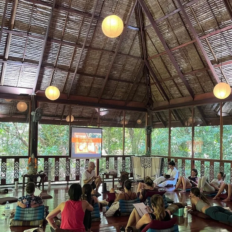 A theory session in the shala, with the jungle framing the space